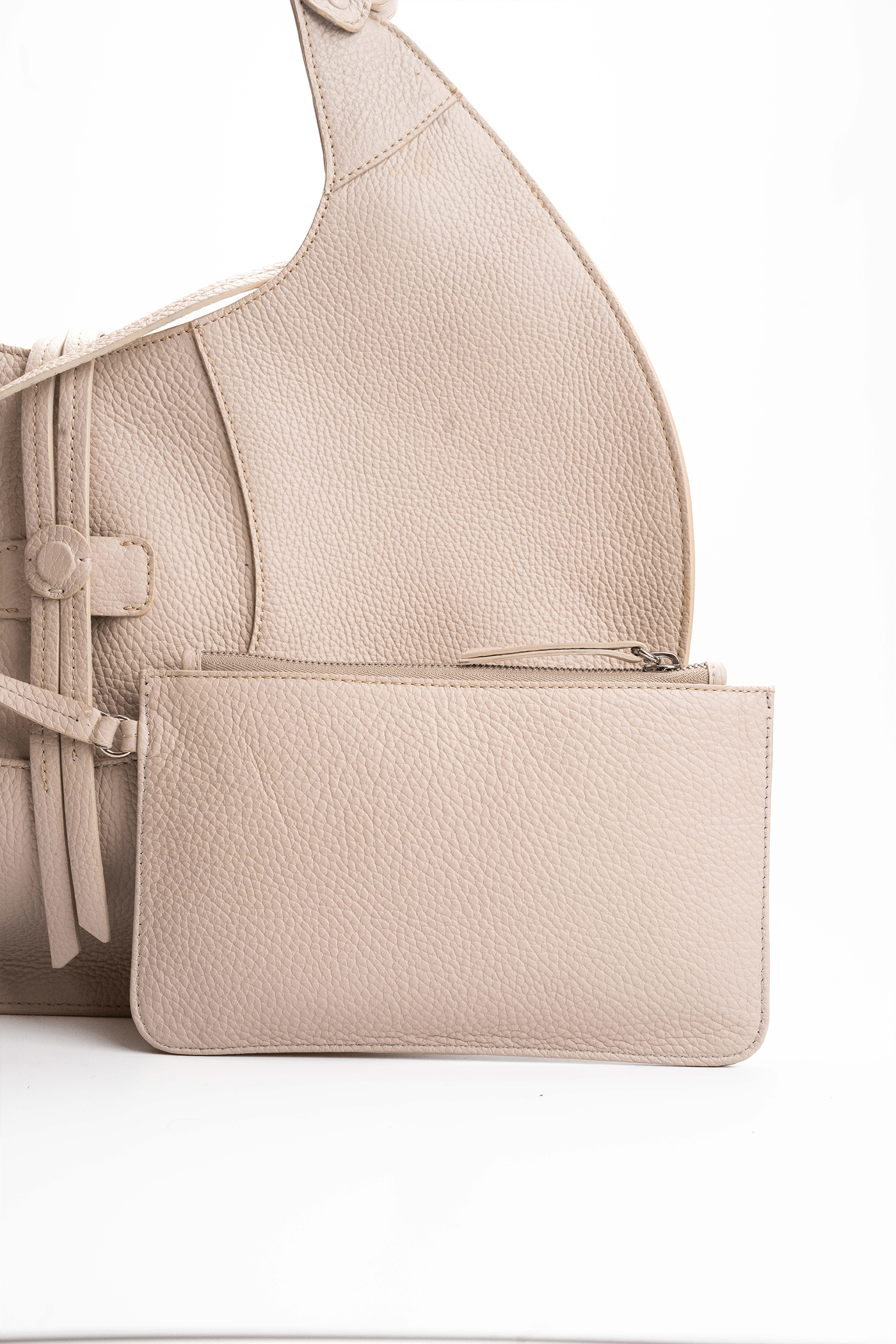 Front view of a beige luxury pebble calf tote bag with a matching small pouch attached by a strap, displayed on a white background.