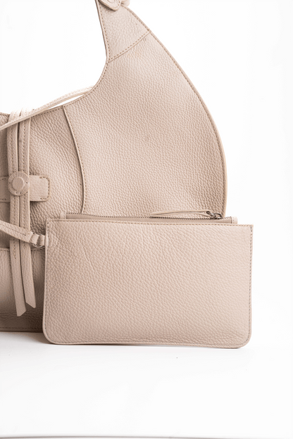 Front view of a beige luxury pebble calf tote bag with a matching small pouch attached by a strap, displayed on a white background.