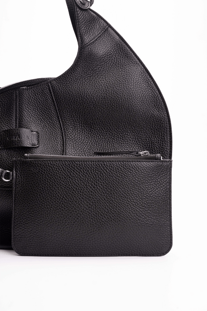 Front view of a black luxury pebble calf tote bag with a matching small pouch attached by a strap, displayed on a white background.