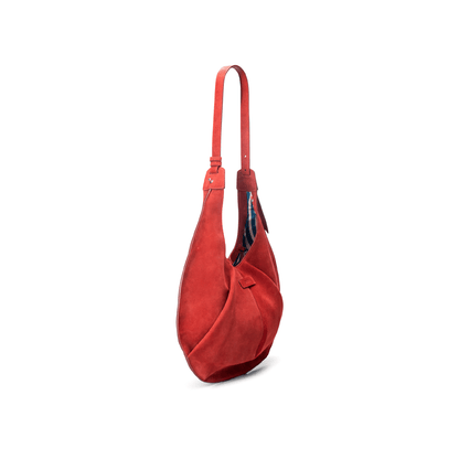 Side view of a large red luxury suede tote handbag on a white background.