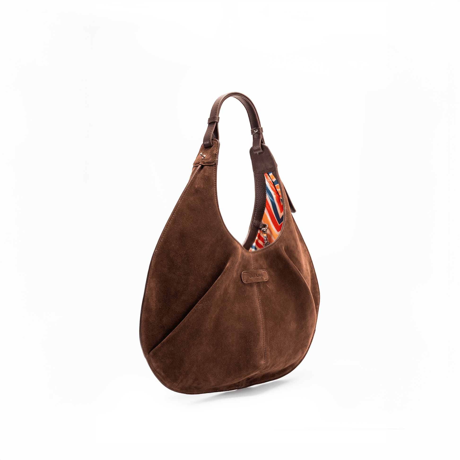 Side view of a large chocolate luxury suede tote handbag on a white background.