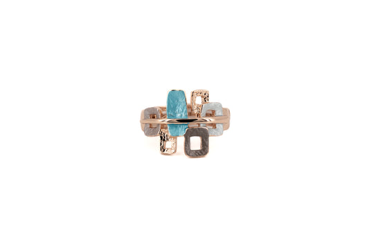 Zamak ring with six overlapping rectangular elements in turquoise, grey, brown and dove grey enamel with rose gold plating