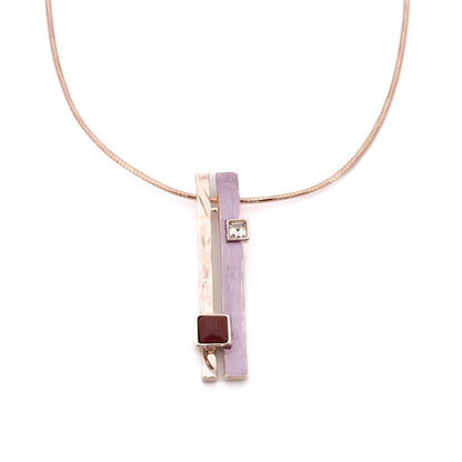A pendant of two slim bars, one hammered rose gold, one hand-painted in soft lilac, hangs side by side from a brass cable necklace that's twisted on itself for extra shine and character.