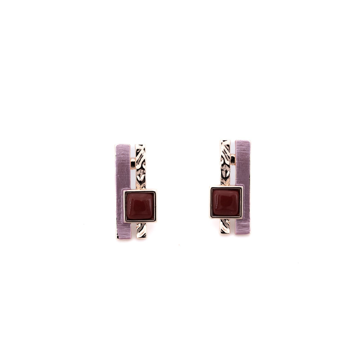 A pair of slim bars, one hand-painted in soft lilac, one hammered rose gold, sit side by side, punctuated by a warm burgundy resin square for a little graphic contrast.