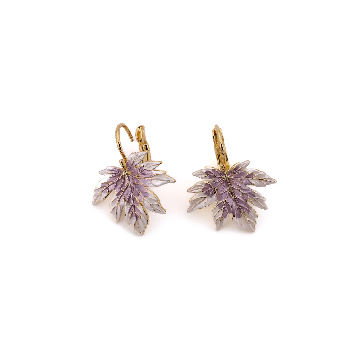 A delicately detailed maple leaf, hand-enamelled in soft lilac and ivory, dangles from a lever-back hook in warm yellow gold against a white background.