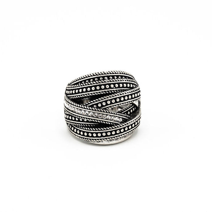 A silver-toned wrap ring with textured twisted bands and rows of small crystals, photographed on a plain white background.