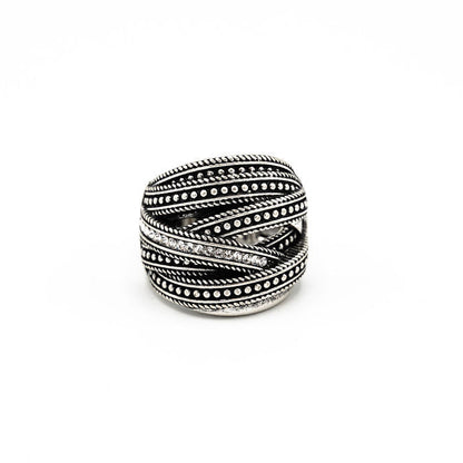 A silver-toned wrap ring with textured twisted bands and rows of small crystals, photographed on a plain white background.