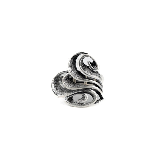 A silver-toned ring with a sculpted, layered design resembling overlapping stylized leaves or petals, shown on a plain white background.