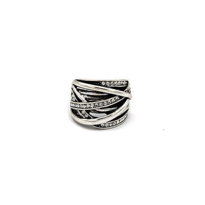 A silver wrap-style ring with twisted bands and small pavé-set clear stones, centered on a plain white background.