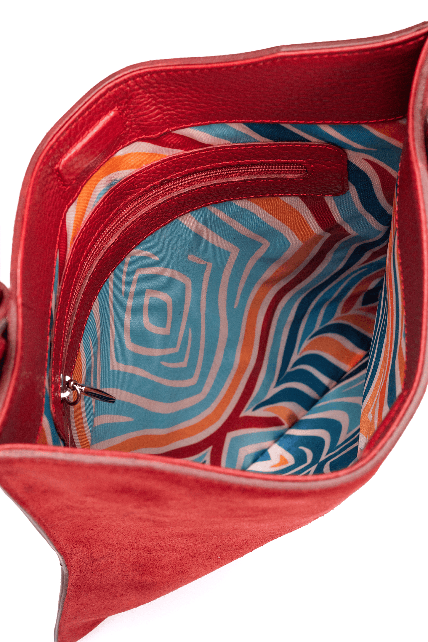 Red crossbody suede leather handbag with a colorful interior linning with a geometric pattern on a white background