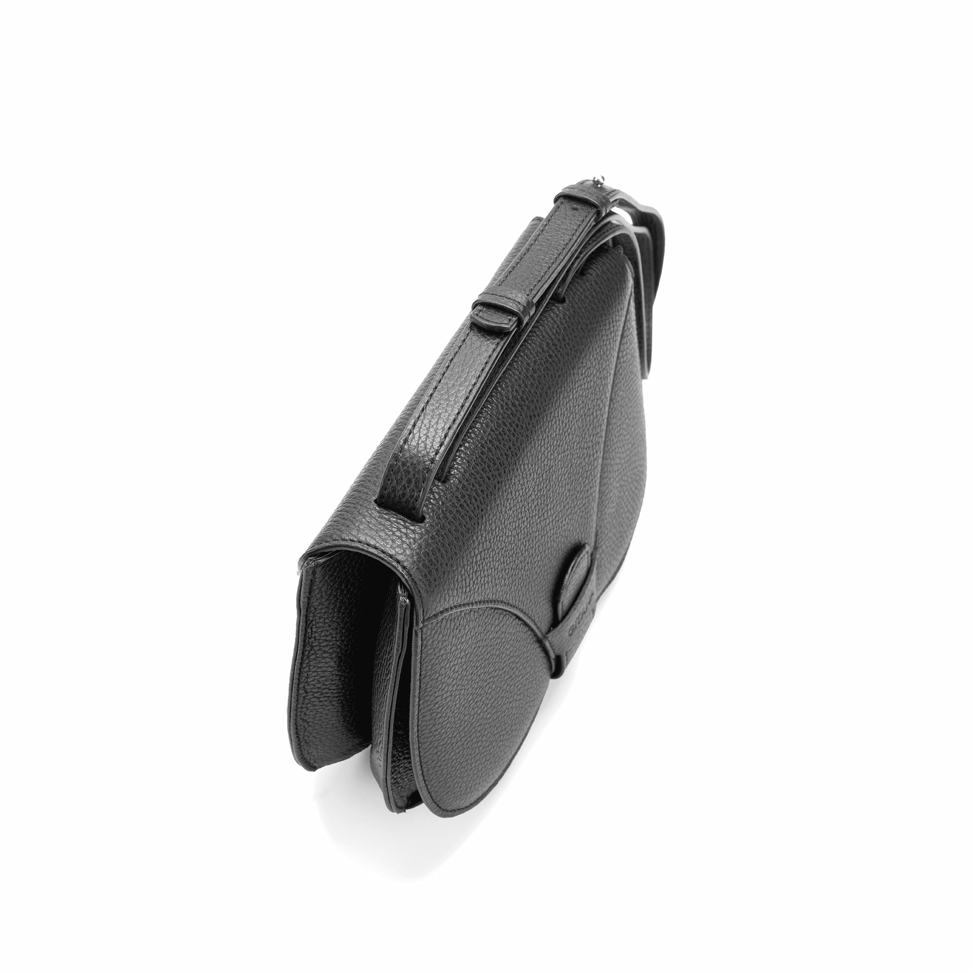 The black Italian pebbled calf leather crossbody handbag seen from above, focusing on the adjustable handle.