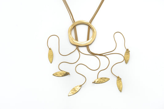 Circle & Leaves Tie Necklace in antique gold with a textured circle pendant and seven cascading leaf-shaped drops on fine chains, product shot on white background