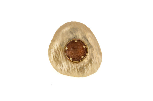 Sun Resin Ring in matt gold with a round brown resin centre set in a sculptural organic-shaped brass disc, top-down product shot on white background