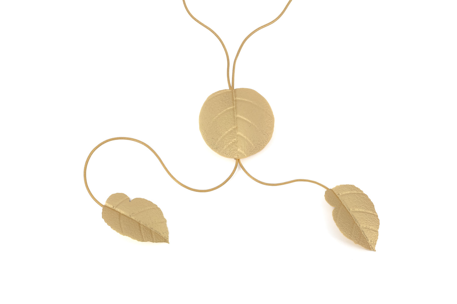 Matt Gold Brass Leaf Necklace product shot showing a large round leaf pendant threaded on a fine gold chain with two smaller leaf pendants cascading from each end, on white background