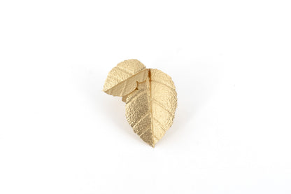 Matt Gold Brass Birch Leaf Ring showing a sculptural adjustable ring with two overlapping textured birch leaf shapes in matt gold finish, product shot on white background