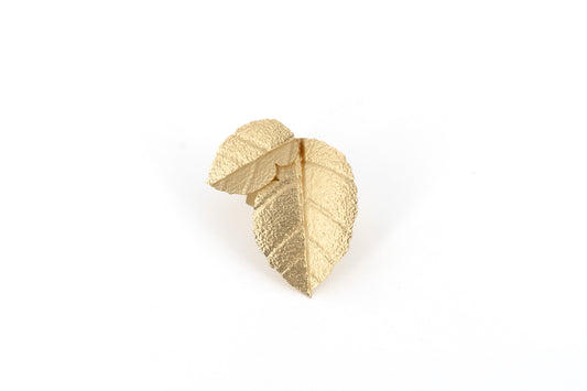Matt Gold Brass Birch Leaf Ring showing a sculptural adjustable ring with two overlapping textured birch leaf shapes in matt gold finish, product shot on white background