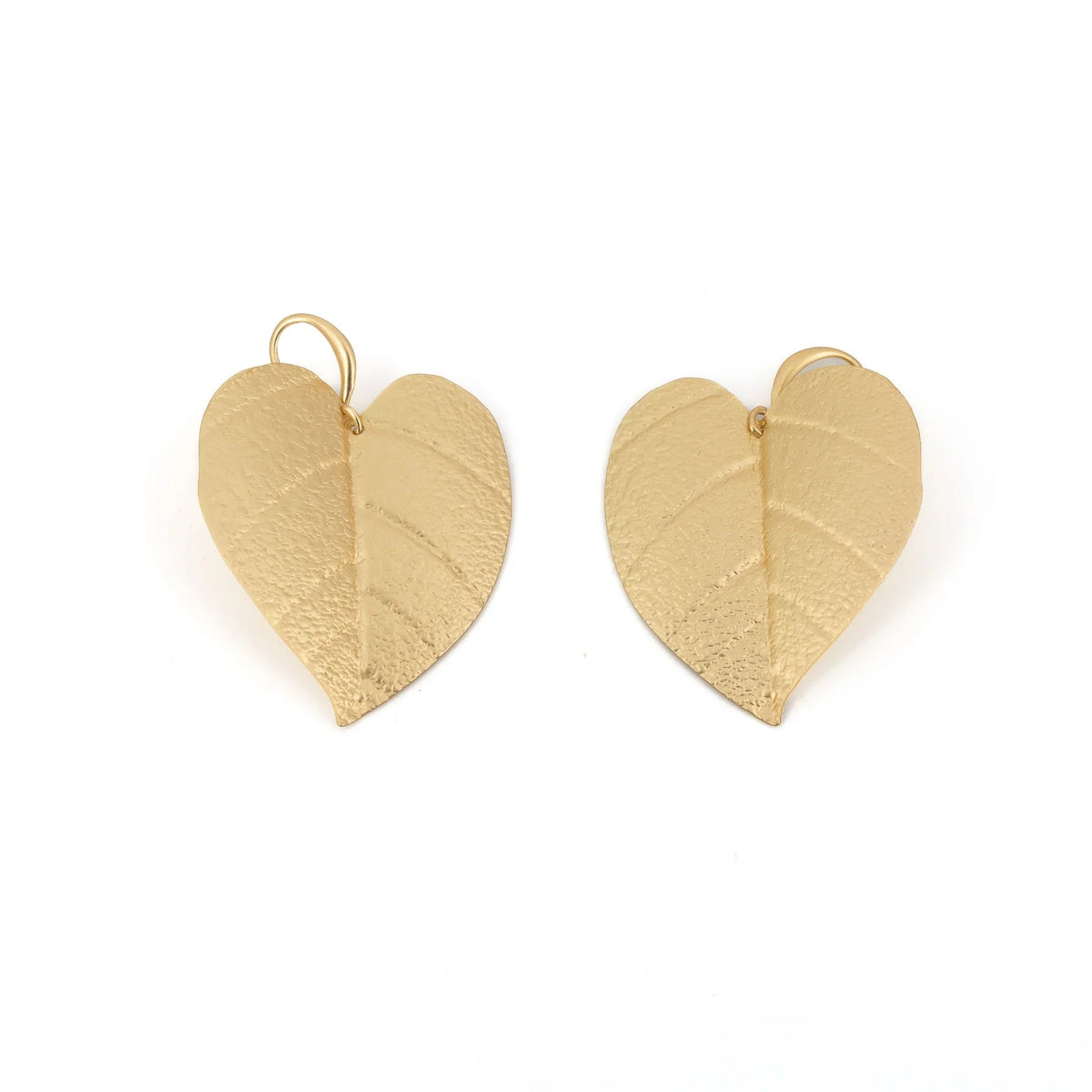 Gold leaf heart-shaped earrings on a white background