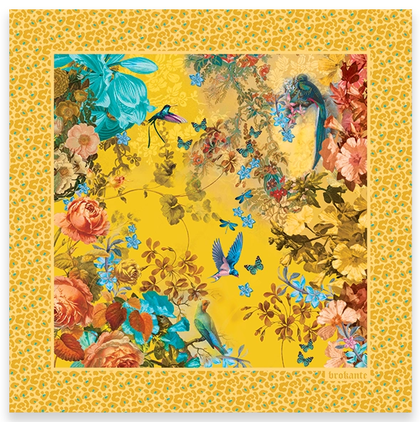 Flat lay / product shot: Rosalia Gold cashmere and modal square scarf laid out flat, with coral roses, turquoise lilies, a hummingbird, birds and small blue butterflies on a saffron-yellow centre, framed by a wide golden leopard-print border.