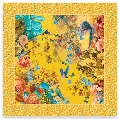 Flat lay / product shot: Rosalia Gold cashmere and modal square scarf laid out flat, with coral roses, turquoise lilies, a hummingbird, birds and small blue butterflies on a saffron-yellow centre, framed by a wide golden leopard-print border.