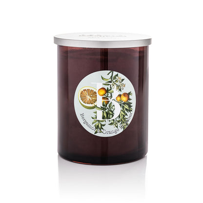 Cereria Pernici Elementi Bergamot & Orange Blossom scented candle in a dark amber glass jar with silver lid, featuring a botanical illustrated label with citrus fruits and orange blossom, product shot on white background