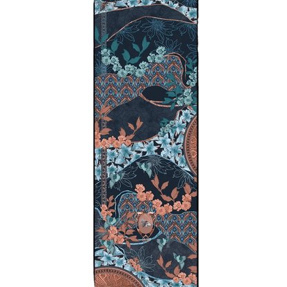 Lys Indigo cashmere and silk scarf print shown flat, with pale blue lilies, mint and coral blossoms, small turquoise birds and a bee in a copper oval medallion on rolling deep indigo hills edged in copper, with coral and blue peacock-feather bands.