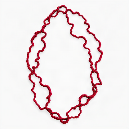 A vibrant long red silk jersey coral necklace on a white background.