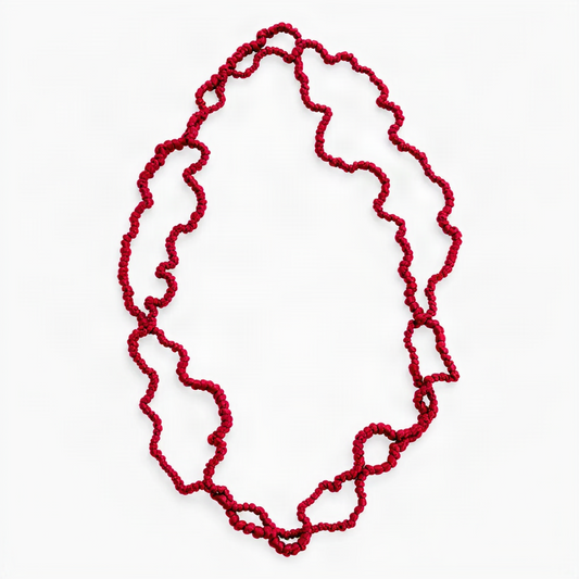 A vibrant long red silk jersey coral necklace on a white background.